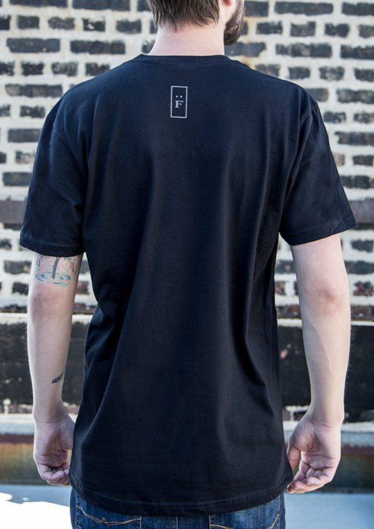 Back of model wearing black tee with "F" graphic.