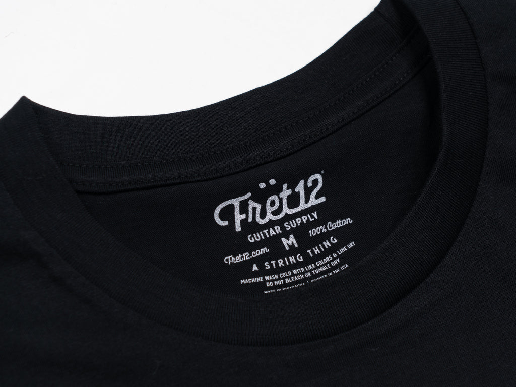 Closeup of black tee with label printed on back of neck. Tagless. 