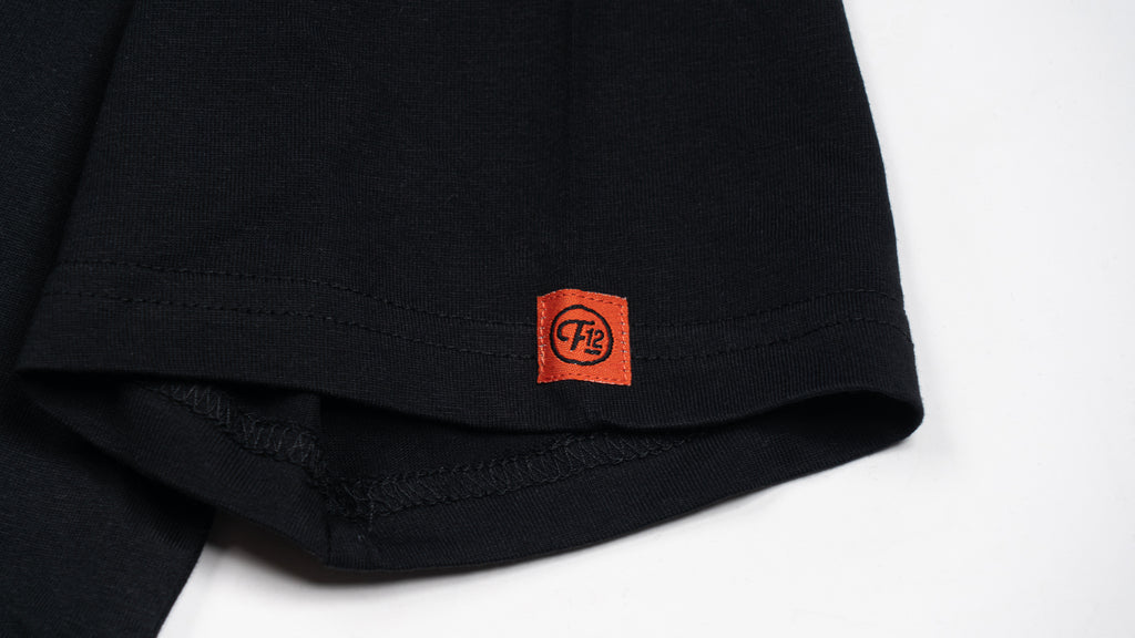 Closeup of orange F12 label on the sleeve's hem.