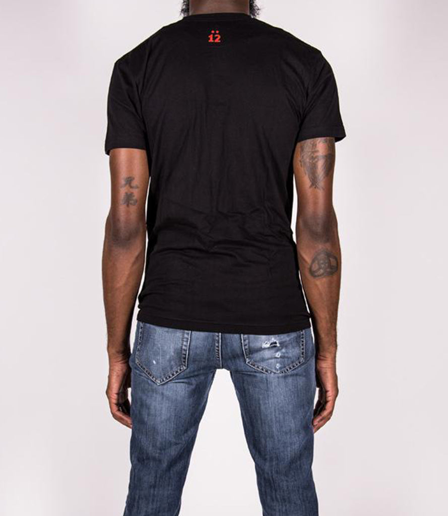 Back of model wearing black tee with O.G. Coil logo.