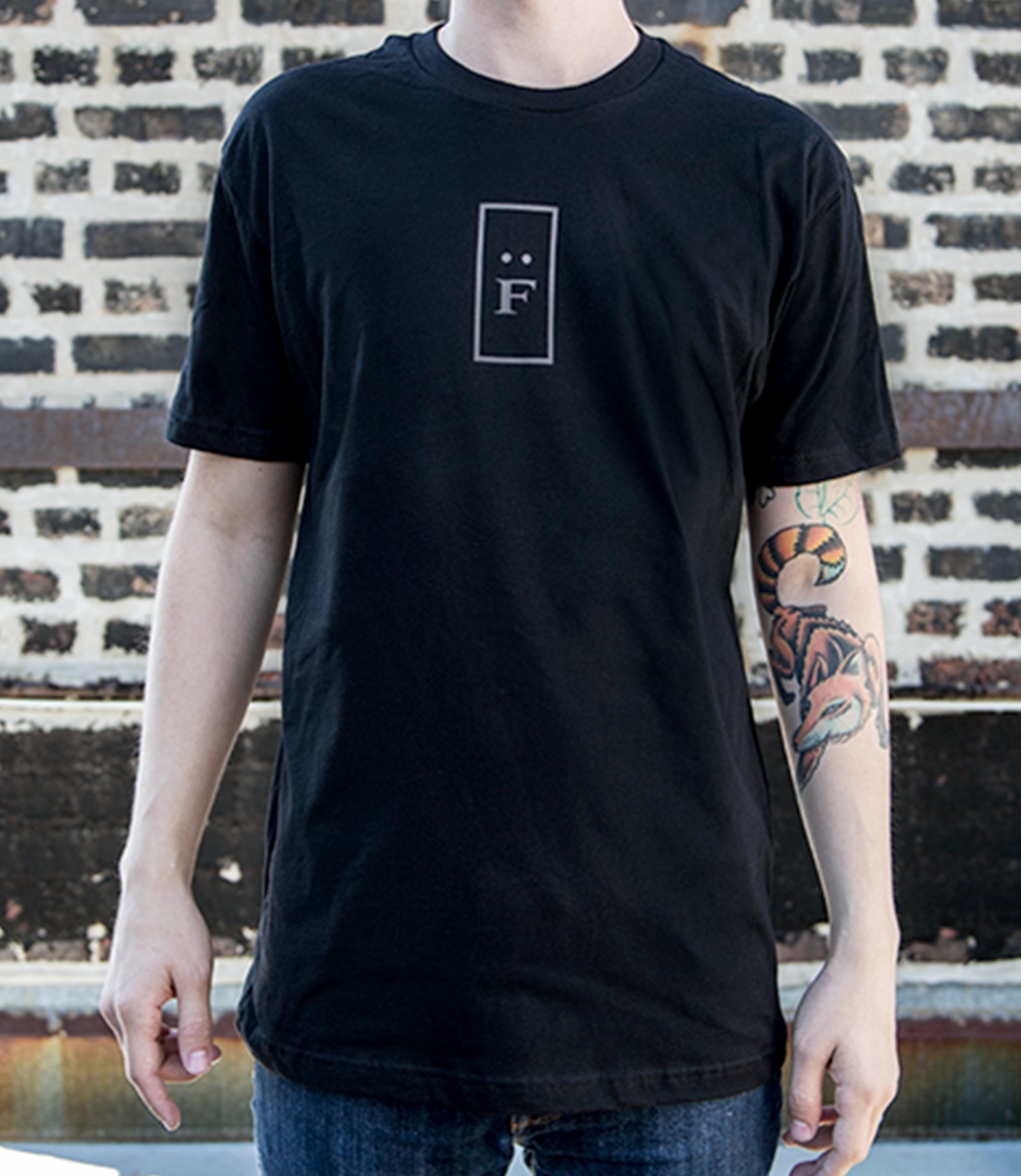 Model wearing black tee with "F" logo.