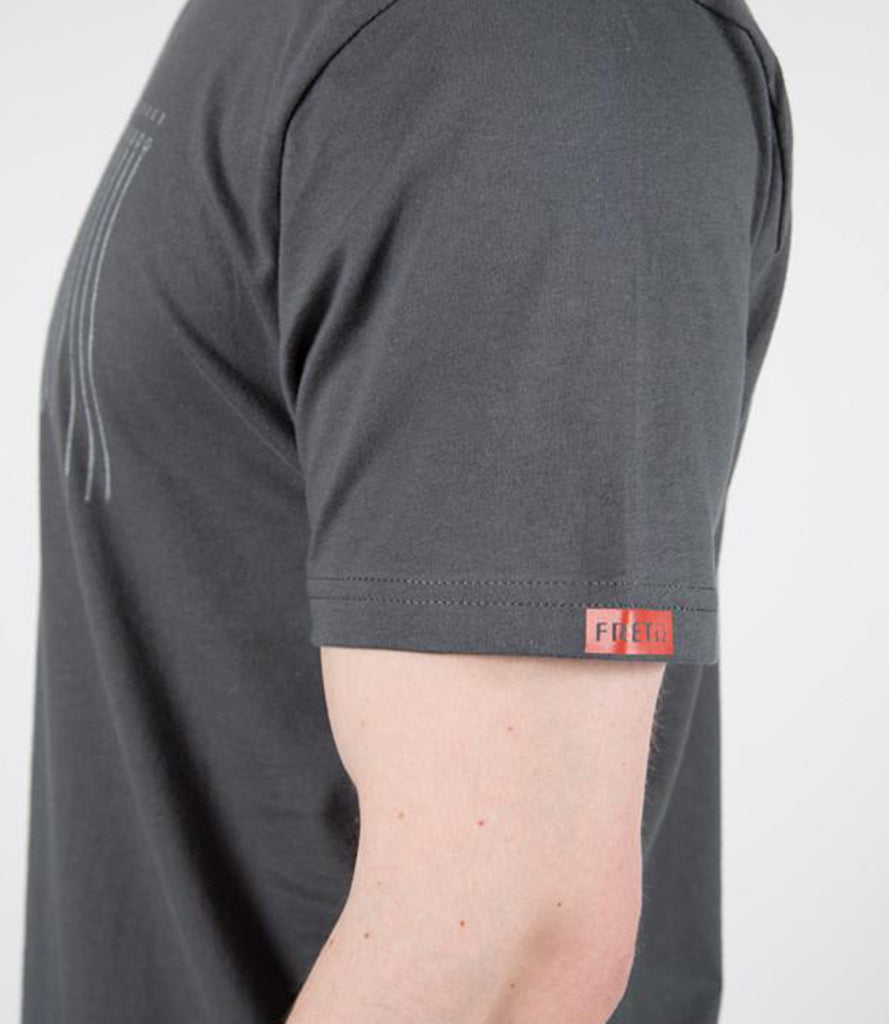 Closeup of model wearing tee with printed Fret12 logo on sleeve.